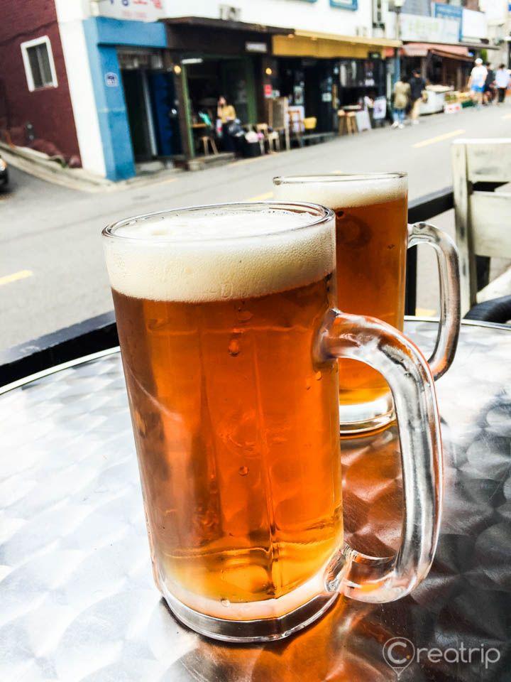 An 8 piece drinkware set including Paulaner Hefeweizen beer glasses on a table in Seoul, Korea.