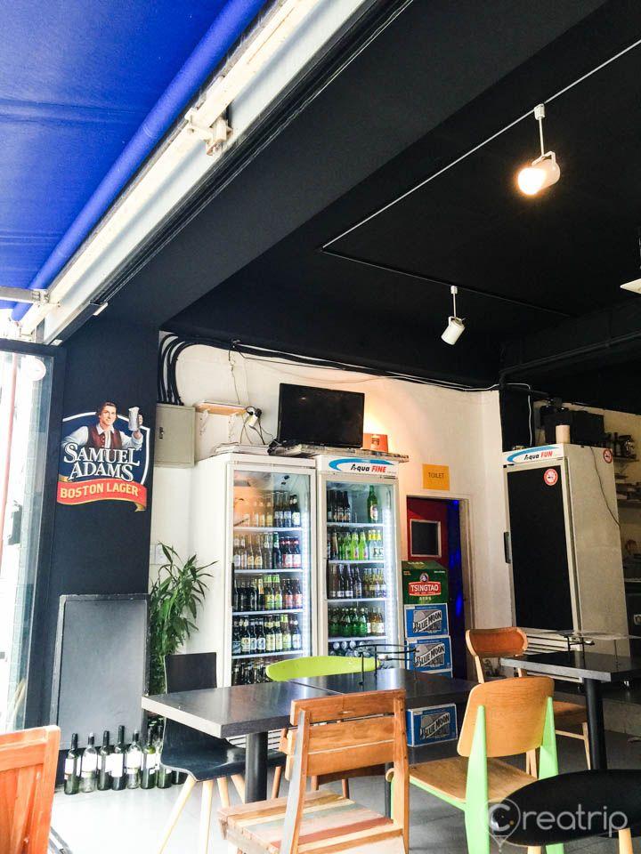 8 piece modern interior design of a restaurant, featuring gas stove, shelving, houseplants, and tables with stools in Seoul, Korea.