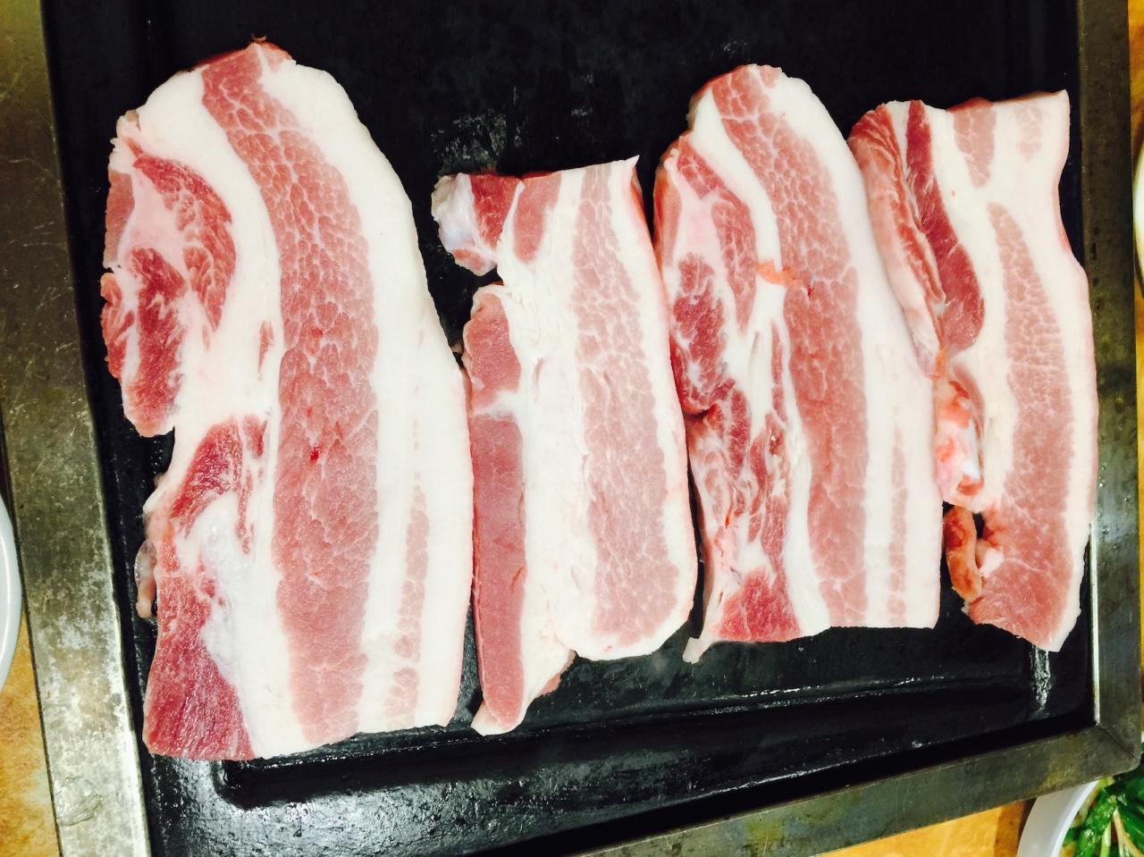 Delicious pork dishes at 서문돌판생삼겹살 restaurant in Korea.