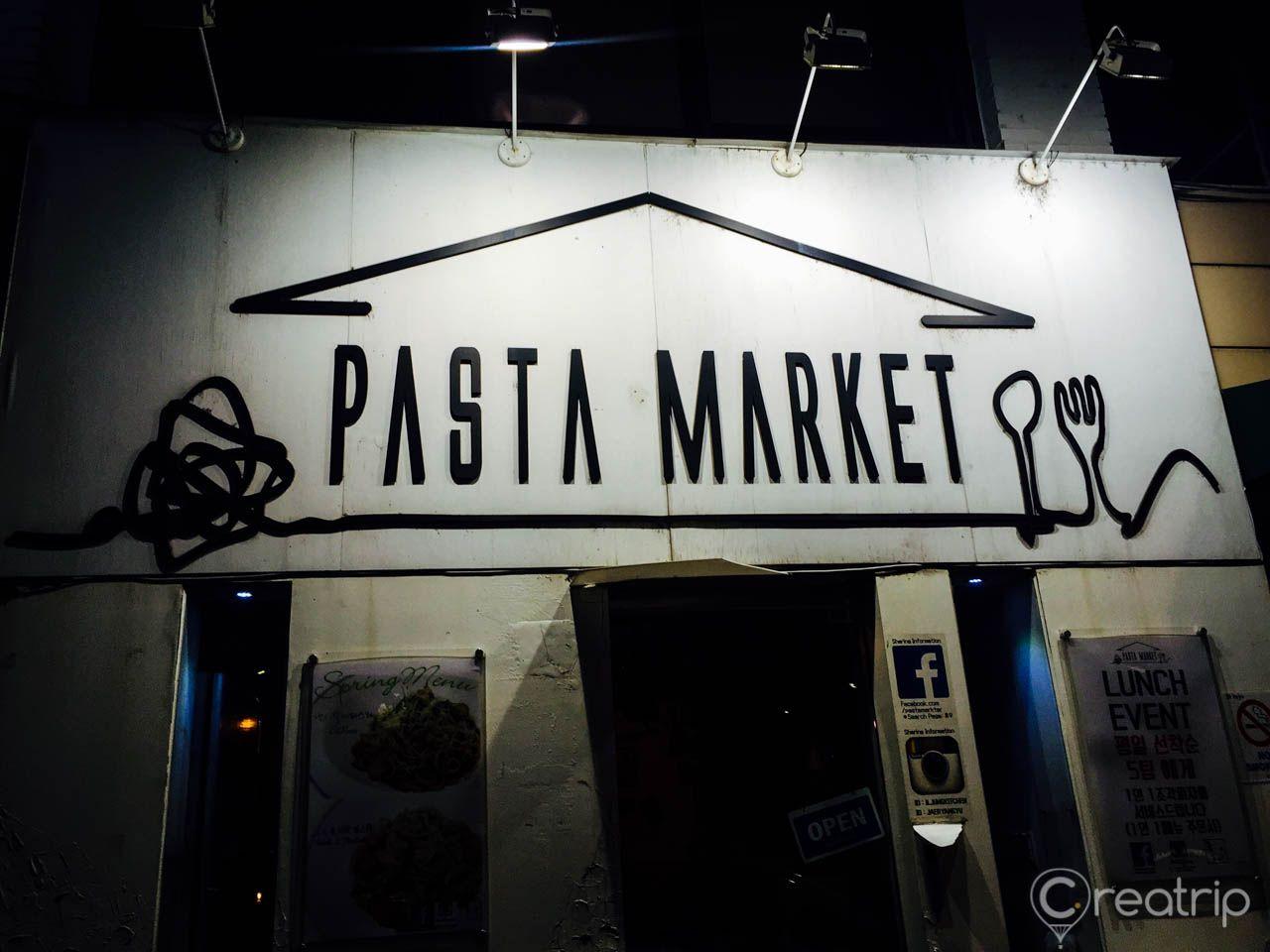 Monochrome signage for Pasta Market with gas fixtures and metal doors in Korea.