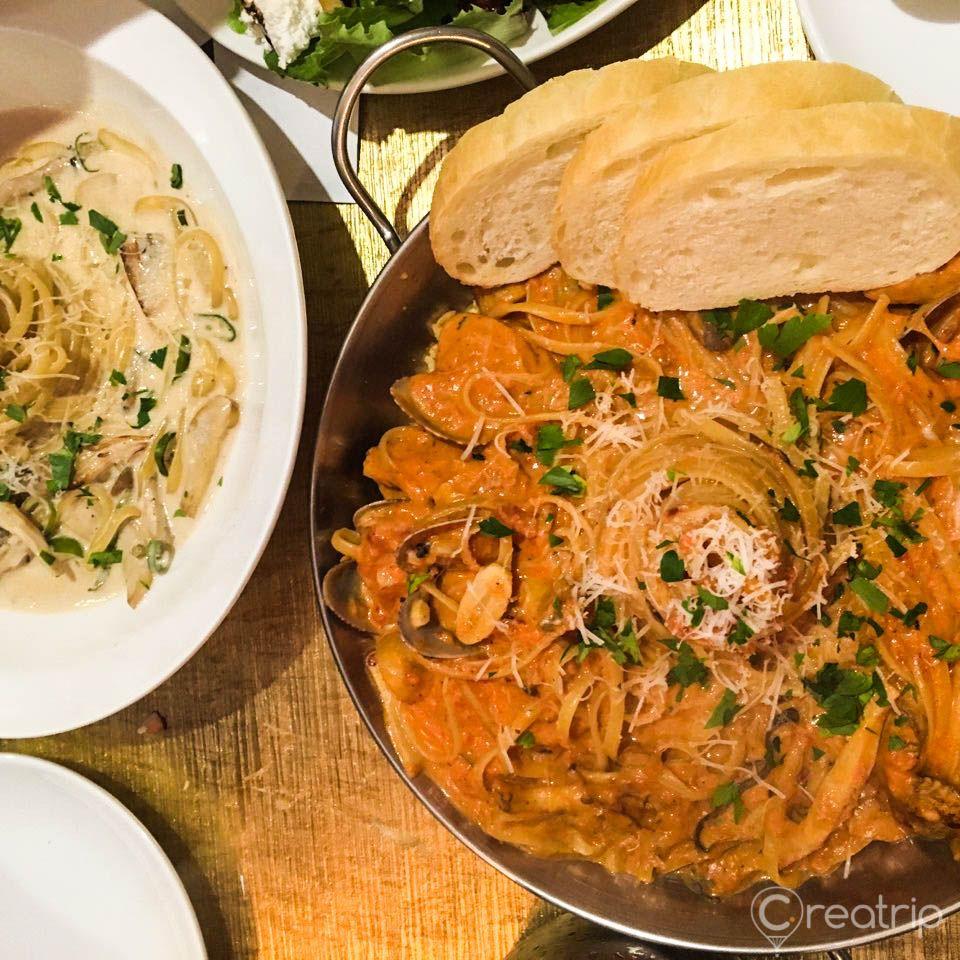 Pasta market restaurant food ingredients, tableware and produce on display.