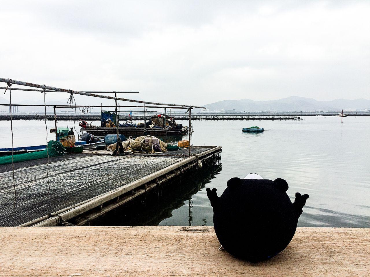 boat on calm lake surrounded by sea and dock in 가덕도 정거마을, Korea.