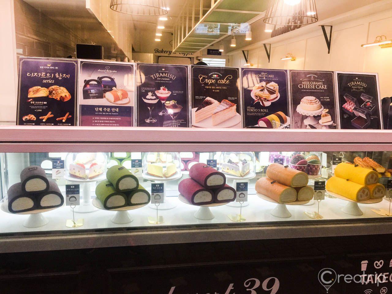 a display case of roll-cakes at Dessert39 in Korea featuring visually appealing graphics and fonts.