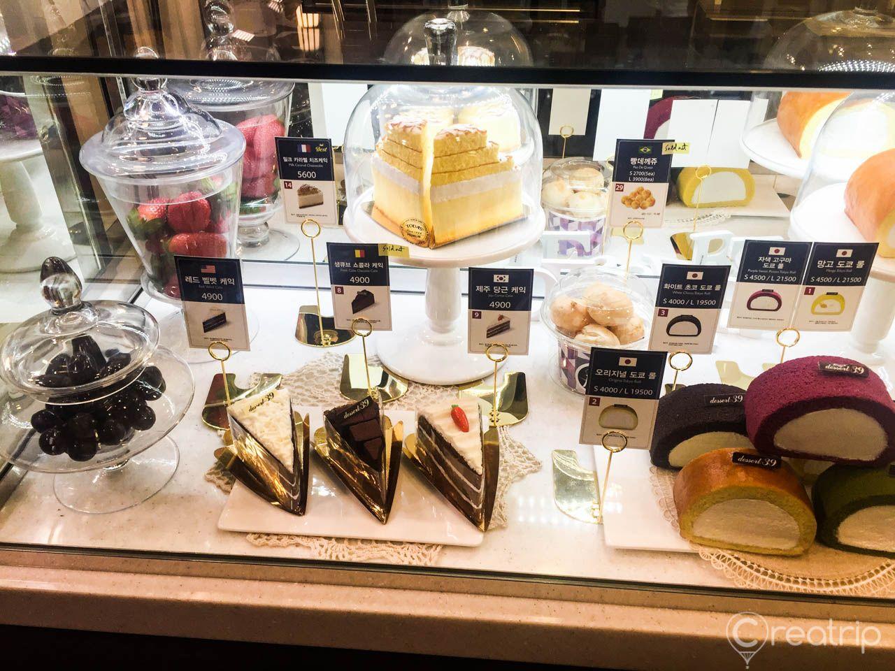 Desserts and eyewear on display at 경리단길점 cafe in Seoul, Korea. Retail products and dishware visible in background.