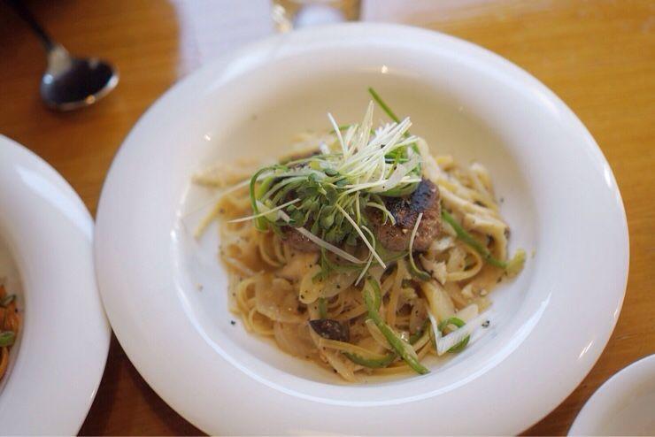 Delicious Korean noodle dish with flavorful ingredients and tableware, perfect for a satisfying meal.