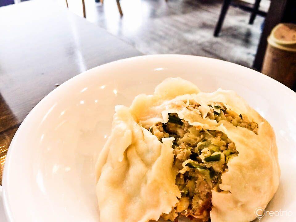 plate of steaming traditional Korean dumplings (mandu) from 평래옥 restaurant. Recipe features unique ingredients and produce for authentic flavor.