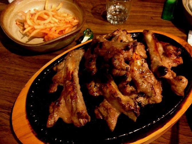 delicious Korean cuisine at Apilip in Yeonnam-dong featuring grilled short ribs, deep-fried chicken, and traditional tableware.