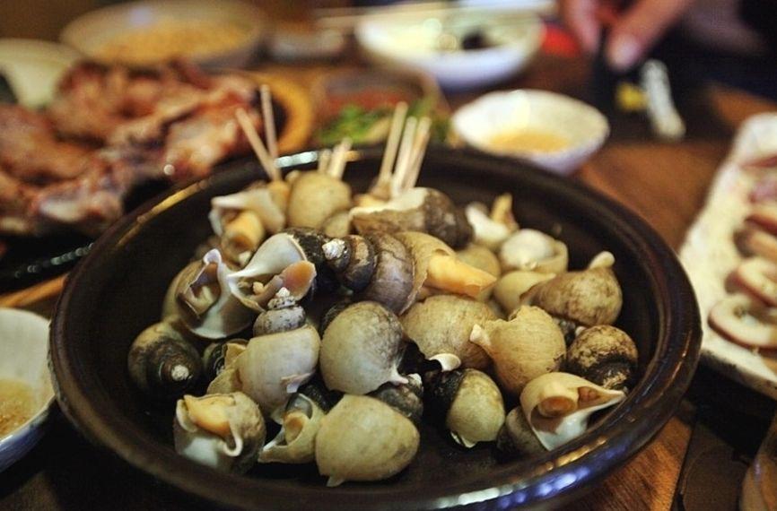 a seafood dish served at a popular restaurant in Yeonnam-dong, Seoul featuring fresh produce, vegetables, and tableware.