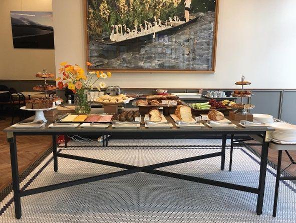 A stylish interior design featuring furniture, plants, and decor with delicious food and coffee.