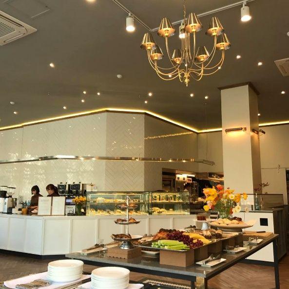 Interior of The Pays Ram with bread, coffee, buffet, and plants in Seoul, Korea.