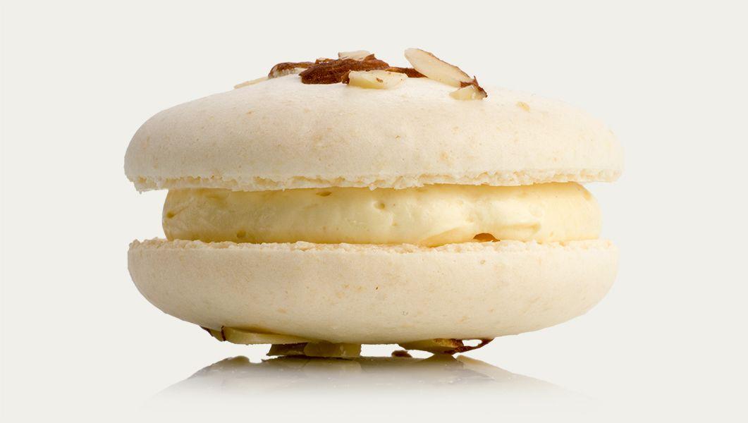 Plate of colorful macarons arranged alongside a milk and cookie monster-inspired drink on a table in Seoul, Korea.
