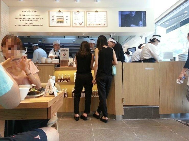 Interior of Baruda Kim Seonseang restaurant in Hongdae with customers sitting at tables.