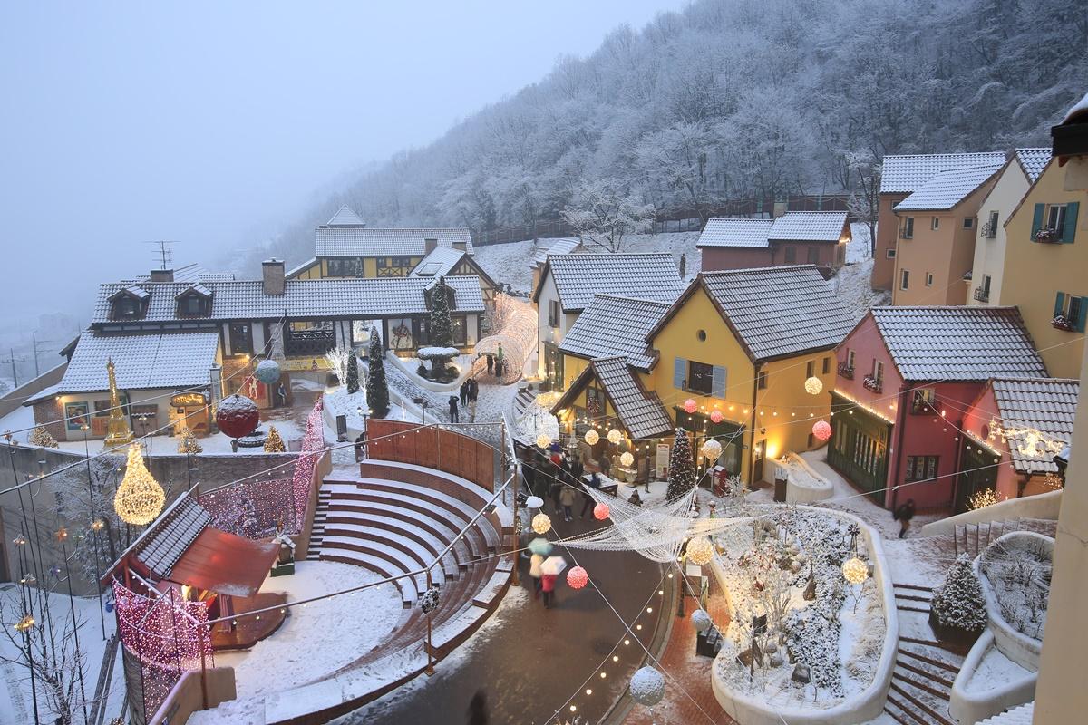 a snow-covered mountain village resembling a French chateau and Italian village