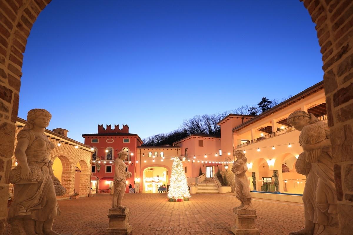 a charming European-style village with Italian amidst lush foliage and a serene sky.