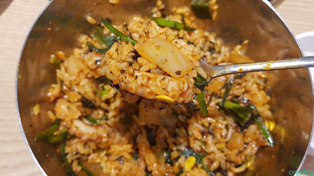 a delicious dish of spicy fried rice with octopus, served at a popular restaurant in Hongdae, Korea.