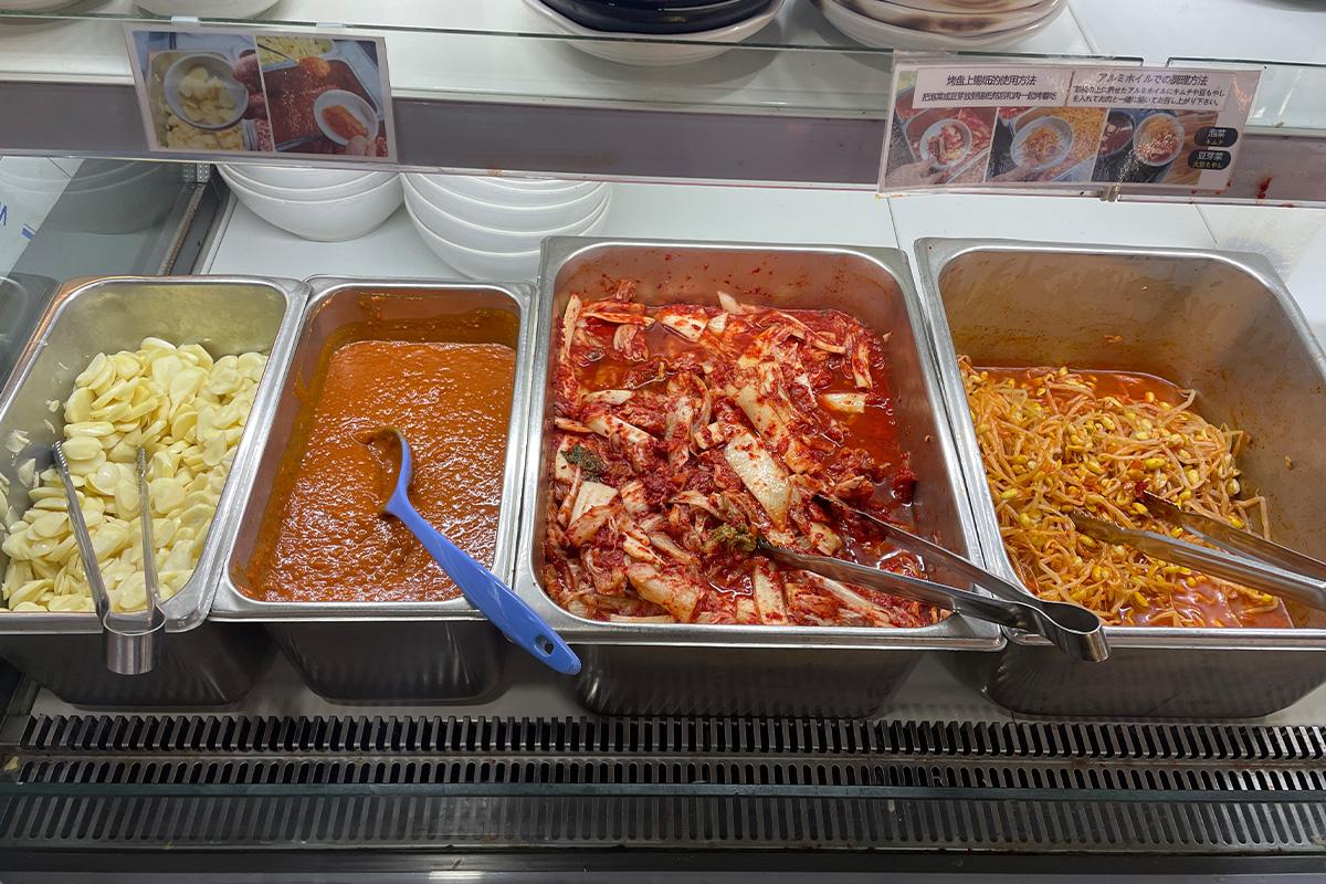 Platter of Korean cuisine dishes, including 엉터리생고기 at 명동점, with self-serve banchan and tableware, for events and recipes.
