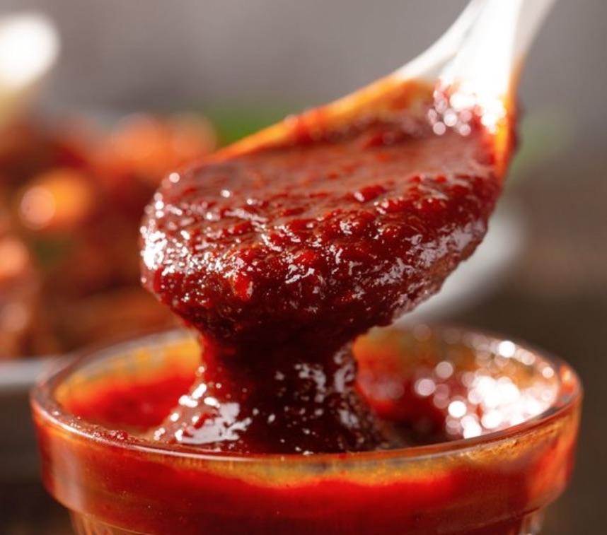 bowl and spoon of spicy marinade sauce
