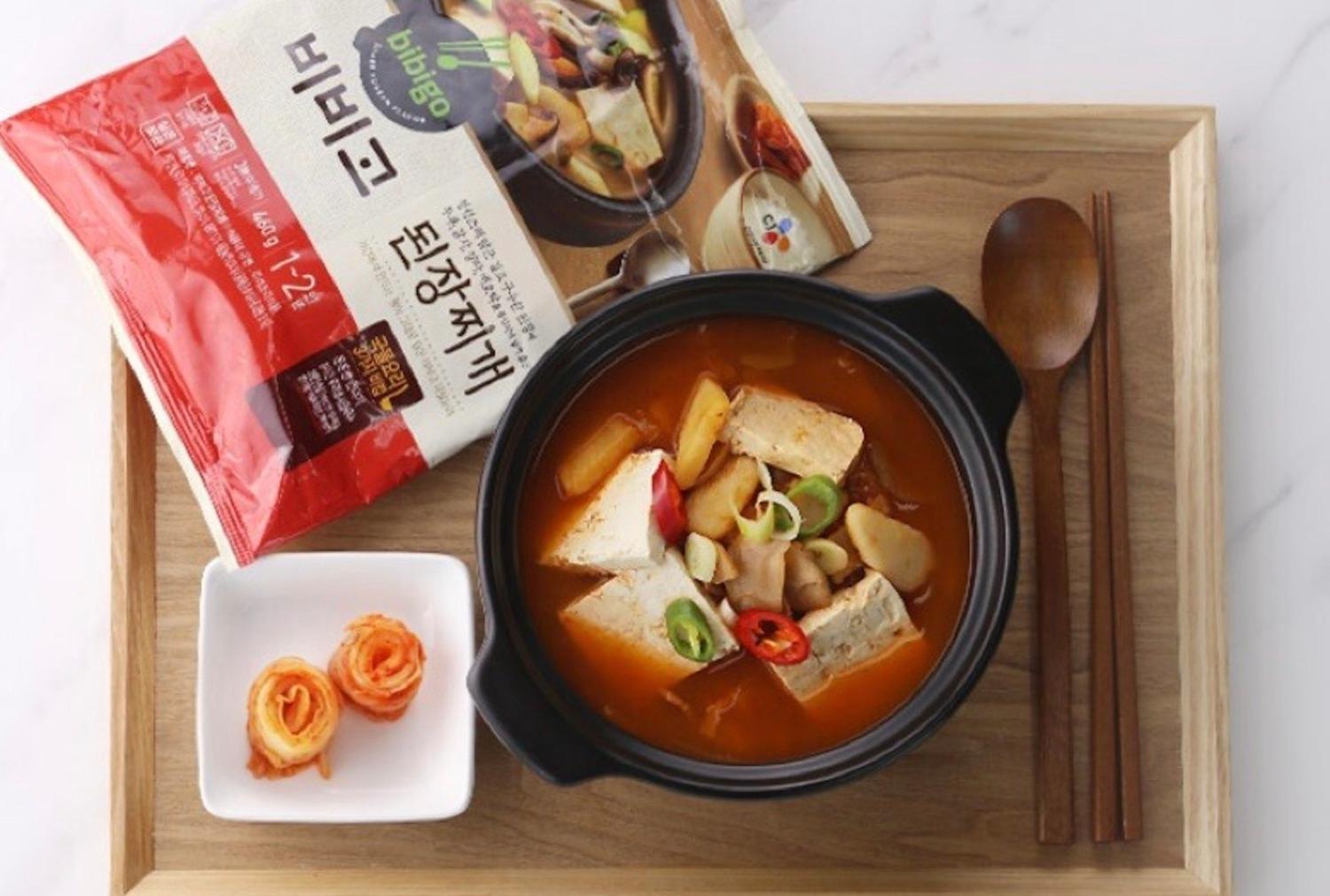 korean brand bibigo's soybean paste stew (Doenjang-jjigae) prepared on a tray with kimchi 