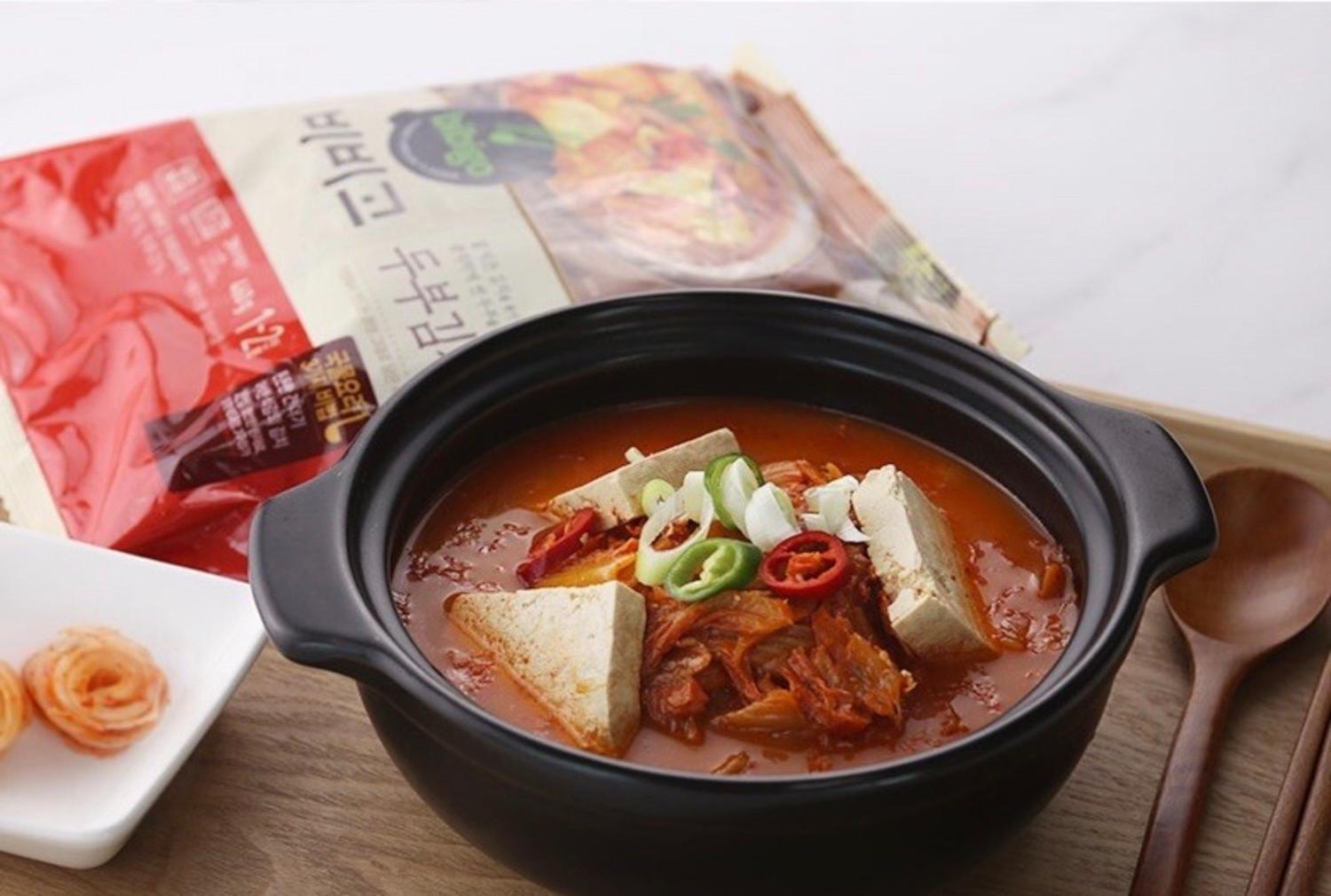 korean brand bibigo's tofu kimchi jjigae in a dish on a tray 