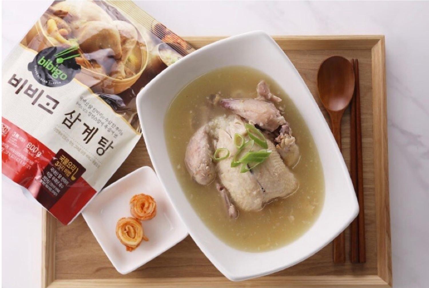 Korean brand bibigo's samgyetang prepared on a tray with kimchi and cutlery 