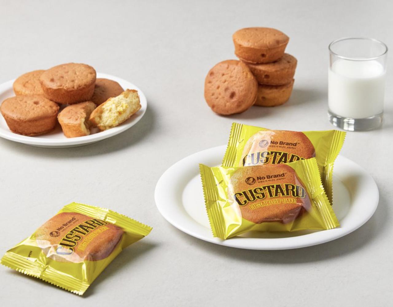 korean brand no brand's custard cup cakes packs and cakes on plates, with a glass of milk