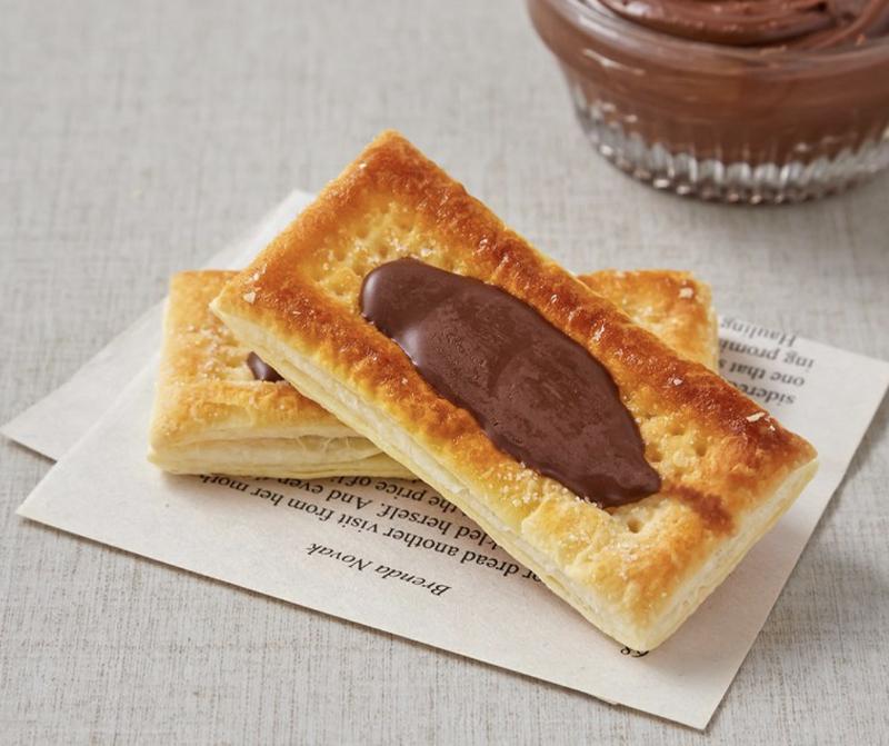 korean brand haitai's french pie chocolate spread on paper with chocolate spread in background