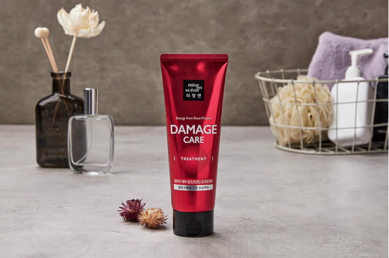 korean brand mise en scene's damage care treatment with bathroom supplies in background