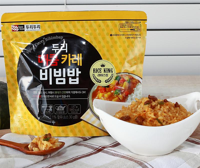 korean brand doori doori's spicy curry bibimbap bag with bowl and spoon full of of rice