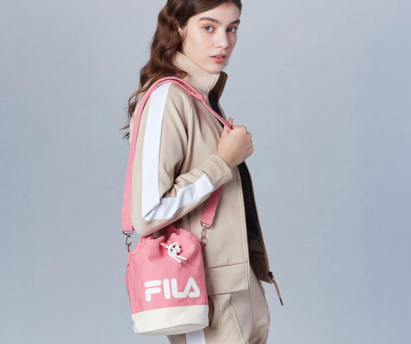 korean fila mini bucket bag in pink held by model