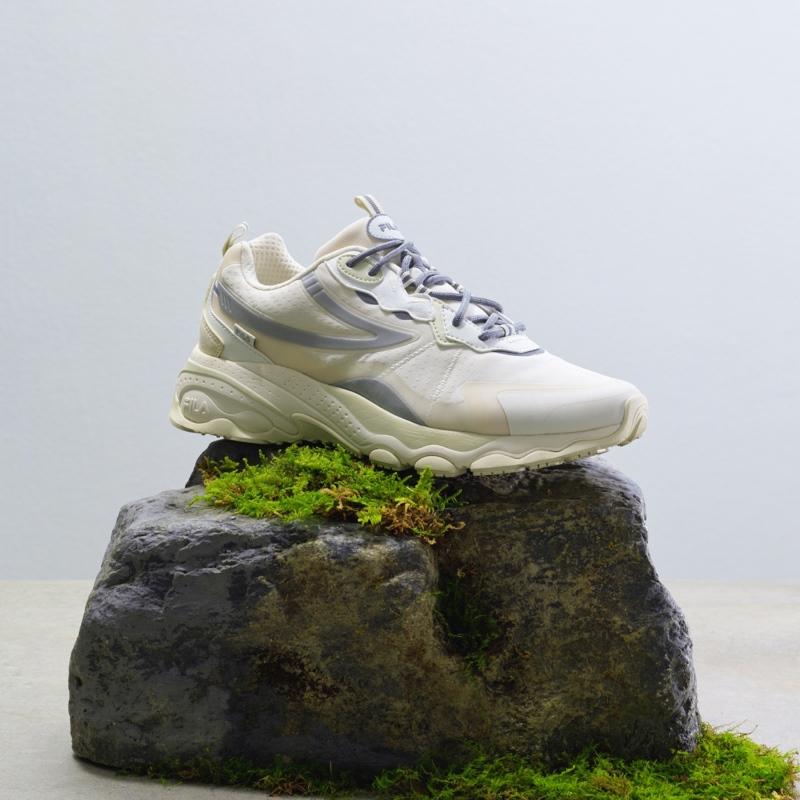 fila korea bubble tr in beige shoe on top of mossy rock