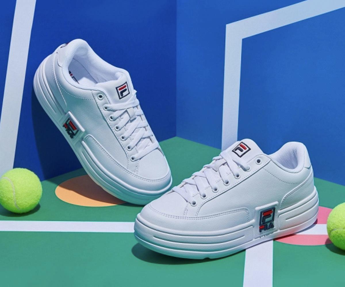 pair of fila korea funky tennis 1998 sneakers with blue and green blocked tennis background