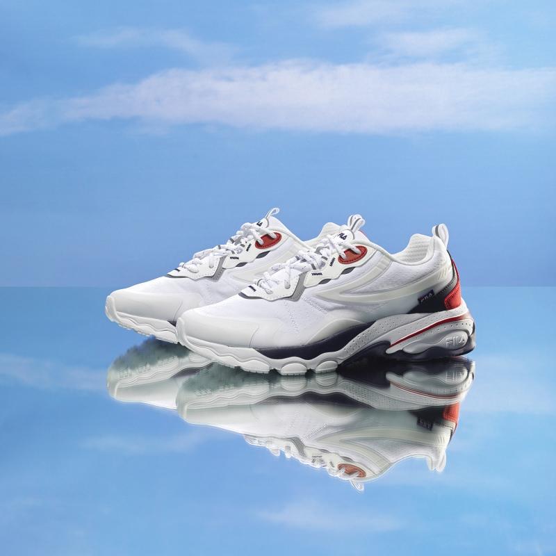 pair of fila korea bubble tr in white and red with sky background