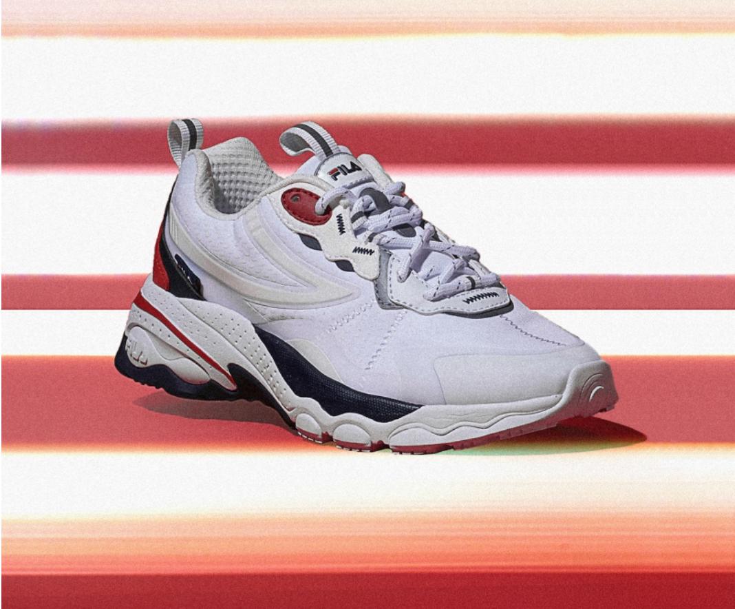 pair of fila korea bubble tr in white and red with red and white stripped background