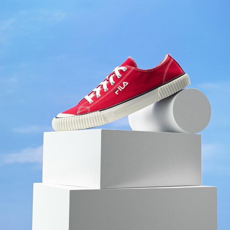fila korea Bumper in Red posed on 3d shapes and with blue sky background