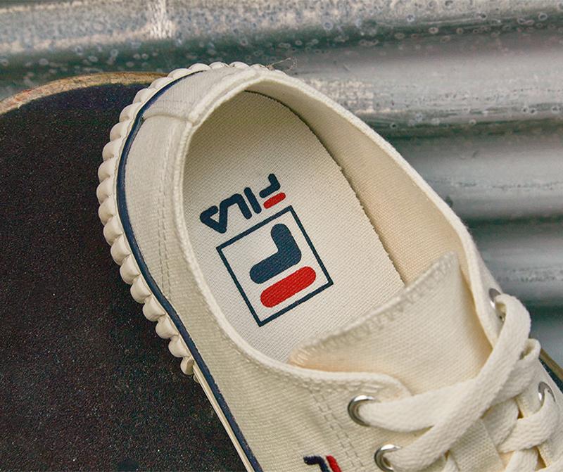 fila korea bumper sneakers in beige close up on inside heel logo