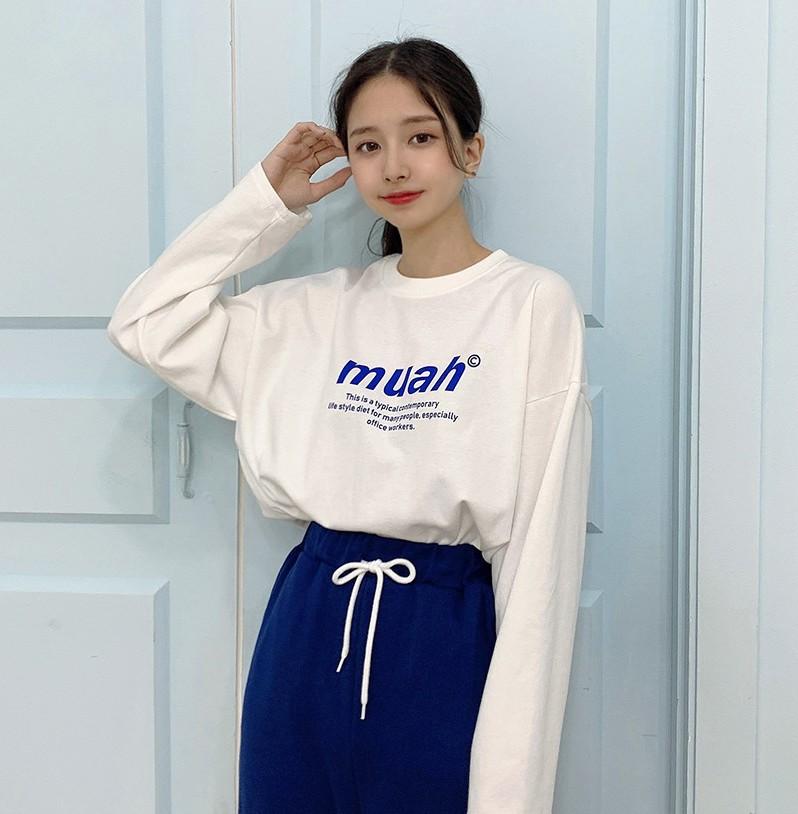 korean brand muah muah signature graphic shirt in white worn with blue pants by model