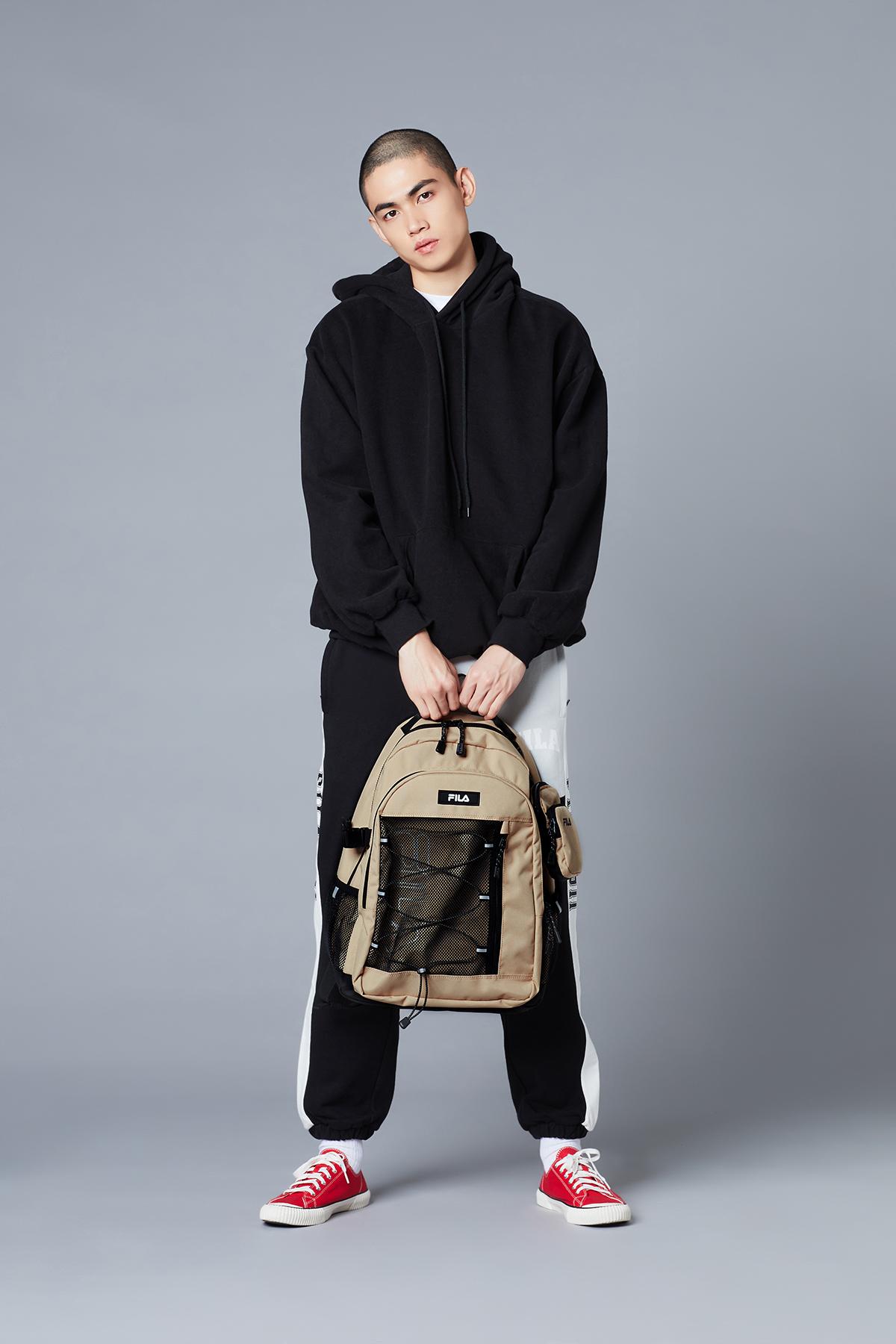 fila korea T-Pack 21 Backpack (true beige) held by handle by model